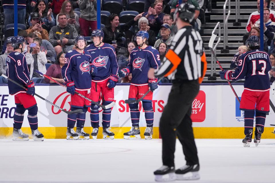 Sep 25, 2022; Columbus, Ohio, USA;  Columbus Blue Jackets defenseman Zach Werenski (8), forward Kent Johnson (91), defenseman Andrew Peeke (2) and left wing Johnny Gaudreau (13) celebrate a goal by left wing Patrik Laine (29) during the second period of the preseason NHL hockey game against the Pittsburgh Penguins at Nationwide Arena. Mandatory Credit: Adam Cairns-The Columbus Dispatch