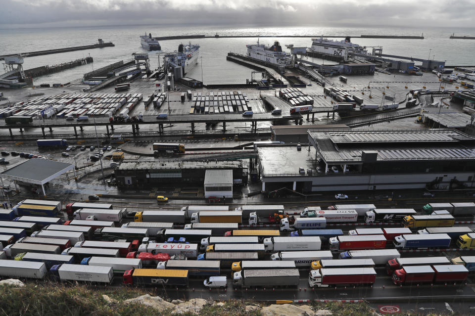 FILE - In this Friday, Dec. 11, 2020 file photo, lorries queue at Check-in at the port in Dover, Britain, before entering the EU. Britain announced Thursday, March 11, 2021 that it is delaying the imposition of checks on some goods from the European Union to give businesses more time to prepare for new post-Brexit rules. The U.K. government says it is postponing full border controls until Jan. 1, six months later than planned, because of disruption caused by the coronavirus pandemic. (AP Photo/Frank Augstein, file)