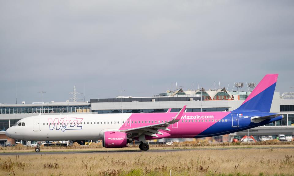 A white, pink, and blue Airbus A321 takes off from Brussels South Charleroi Airport to Sofia.