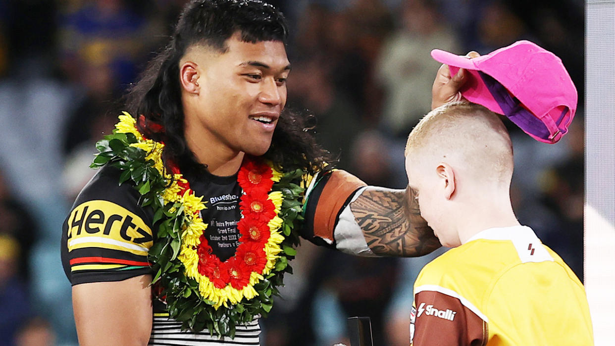 Brian To'o, pictured here handing the pink Telstra hat to a young footballer after the NRL grand final. 