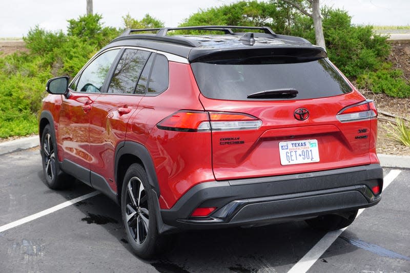 A red 2023 Toyota Corolla Cross Hybrid.