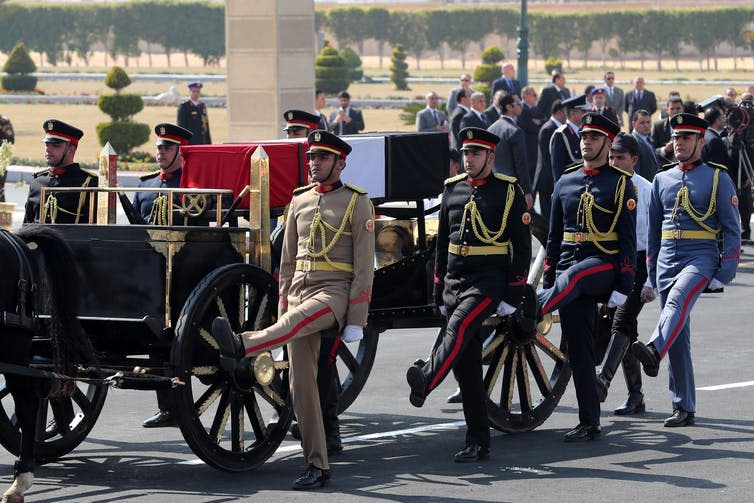 <span class="caption">Officers escort the flag-draped coffin former Egyptian President Hosni Mubarak.</span> <span class="attribution"><span class="source">EFE-EPA/Khaled Elfiqi</span></span>