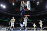 Georgetown's Qudus Wahab, left, goes up for a dunk against Villanova's Justin Moore during the first half of an NCAA college basketball game, Saturday, Jan. 11, 2020, in Philadelphia. (AP Photo/Matt Slocum)