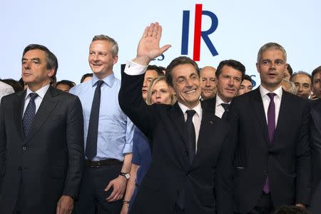 Nicolas Sarkozy, former French president and head of the newly renamed "The Republicans" political party, Former Prime Minister Francois Fillon (L), politicians Bruno Le Maire (2nd L) and Laurent Wauquiez (R) stand on the stage at the end of a rally in Paris, France, May 30, 2015. REUTERS/Philippe Wojazer