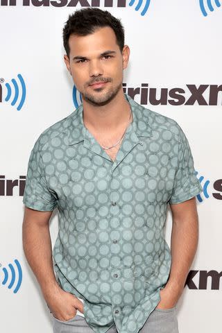 <p>Jamie McCarthy/Getty</p> Taylor Lautner visits SiriusXM at SiriusXM Studios on May 17, 2023