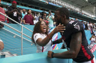 Atlanta Falcons tight end Kyle Pitts (8) is congratulated by a fan, as he leaves the field after the Falcons defeated the Miami Dolphins 30-28 in their NFL football game, Sunday, Oct. 24, 2021, in Miami Gardens, Fla. (AP Photo/Hans Deryk)