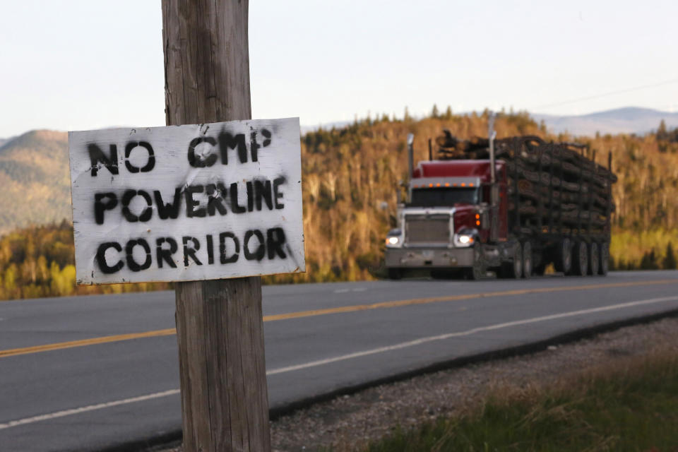 FILE - A homemade sign is posted on a telephone pole in protest of Central Maine Power's controversial hydropower transmission corridor in Jackman, Maine, May 28, 2019. The Maine Department of Environmental Protection announced that construction of a transmission line could resume after state voters opposed the project in an election. (AP Photo/Robert F. Bukaty, File)
