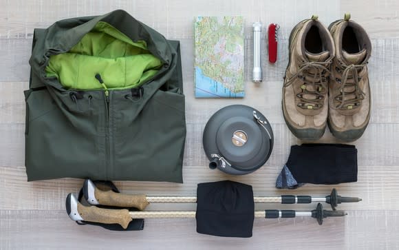 Hiking apparel and equipment arranged neatly on a table