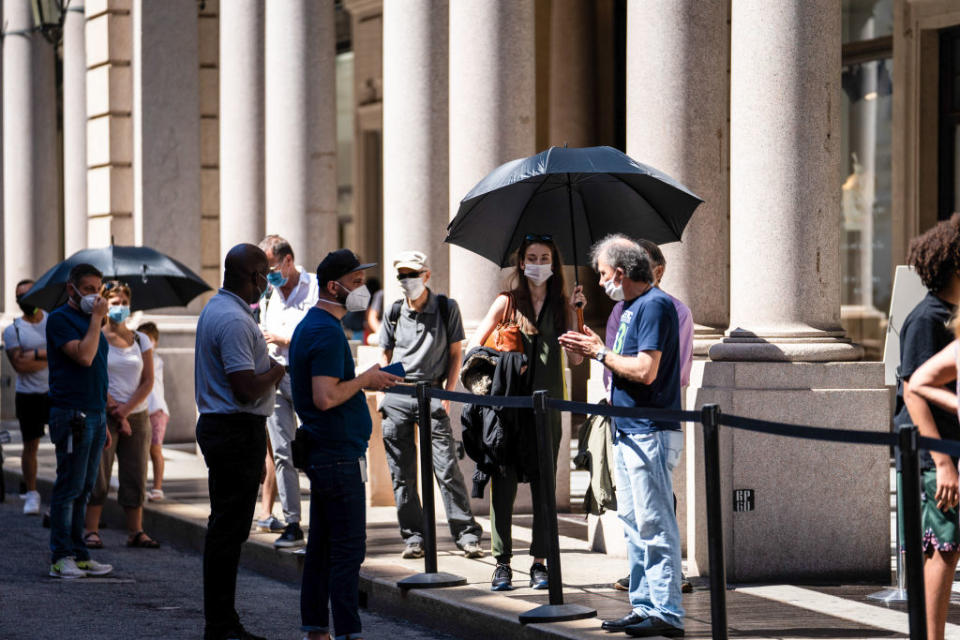 Pedestrians adopt a safe social distance as they stand in line outside an Apple Inc. store in Turin, Italy, on Tuesday, June 23, 2020. Italian Prime Minister Giuseppe ConteÂ said his government would likely seek a wider budget gap as he draws up an ambitious reform plan to lobby for European Union assistance to restart the economy. Photographer: Federico Bernini/Bloomberg