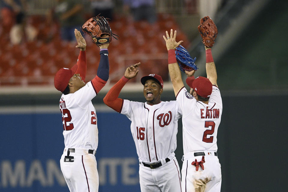 Washington Nationals' Juan Soto, left, Victor Robles, center, and Adam Eaton, right, celebrate after a baseball game against the Philadelphia Phillies, Monday, Sept. 23, 2019, in Washington. (AP Photo/Nick Wass)