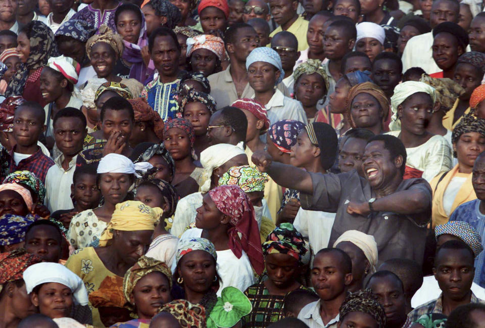 FILE - In this Dec. 5, 2001, file photo, a man sings and dances during Reinhard Bonnke's "Great Gospel Crusade," in Osogbo, Nigeria. Bonnke, a Pentecostal preacher whose crusades across Africa drew millions with the promise of faith healings, died Dec. 7, 2019, the ministry he founded announced. He was 79. (AP Photo/Christine Nesbitt, File)