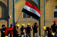 Demonstrators take part in the ongoing anti-government protests in Baghdad