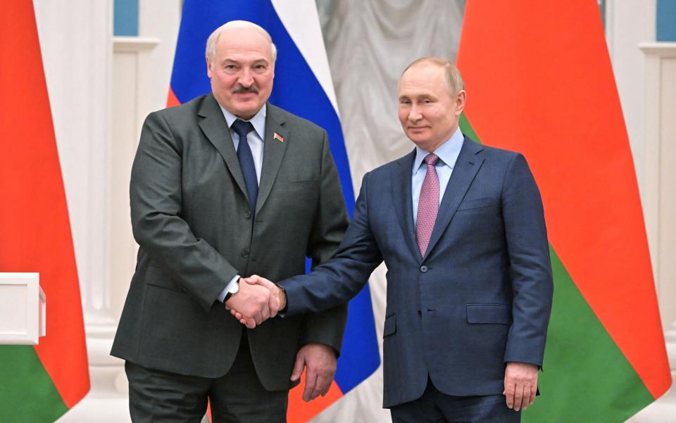 Russia's President Vladimir Putin (R) shakes hands with his Belarus counterpart Alexander Lukashenko (L) during a press conference following their talks at the Kremlin in Moscow on February 18, 2022.