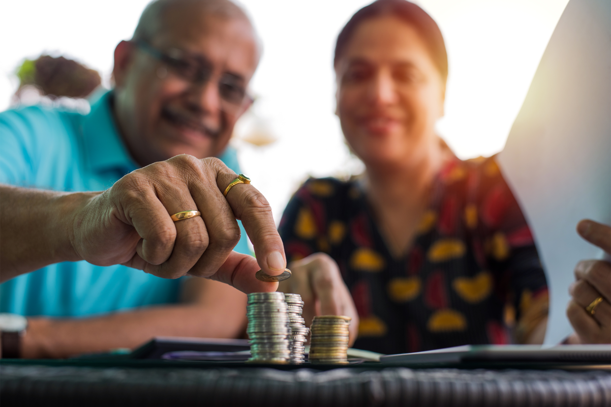 Senior Indian couple saving money