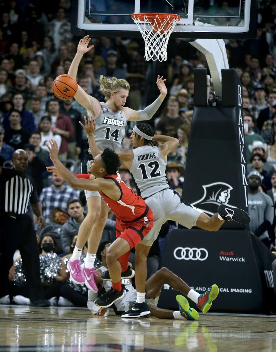 Providence College's Noah Horchler, Brycen Goodine and Al Durham converge under the net to stop Texas Tech's Terrence Shannon, Jr. from scoring during a Big 12-Big East Battle contest Dec. 1 at the Dunkin' Donuts Center in Providence, Rhode Island.