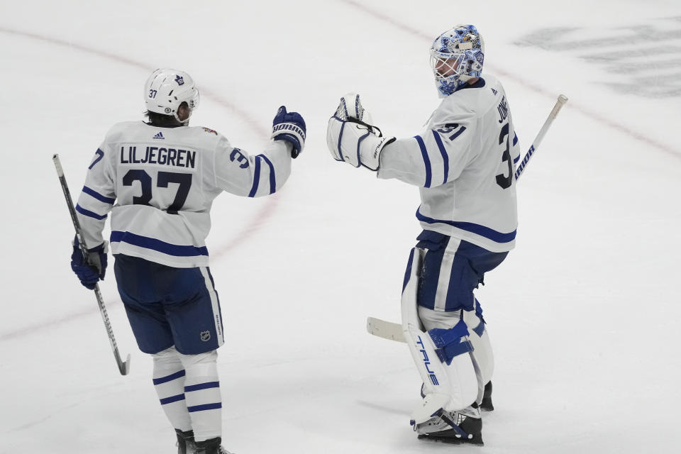 Toronto Maple Leafs goaltender Martin Jones, right, celebrates with defenseman Timothy Liljegren after the Maple Leafs defeated the San Jose Sharks in an NHL hockey game in San Jose, Calif., Saturday, Jan. 6, 2024. (AP Photo/Jeff Chiu)