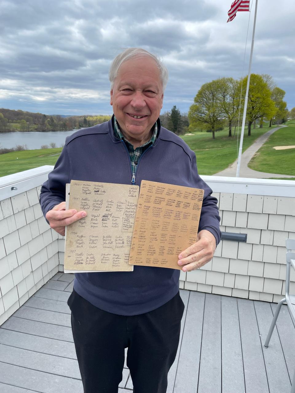 On Green Hill Municipal Golf Course’s deck, Tom Mullins holds the lists of names, courses and years he’s organized southern golf trips since 1993.