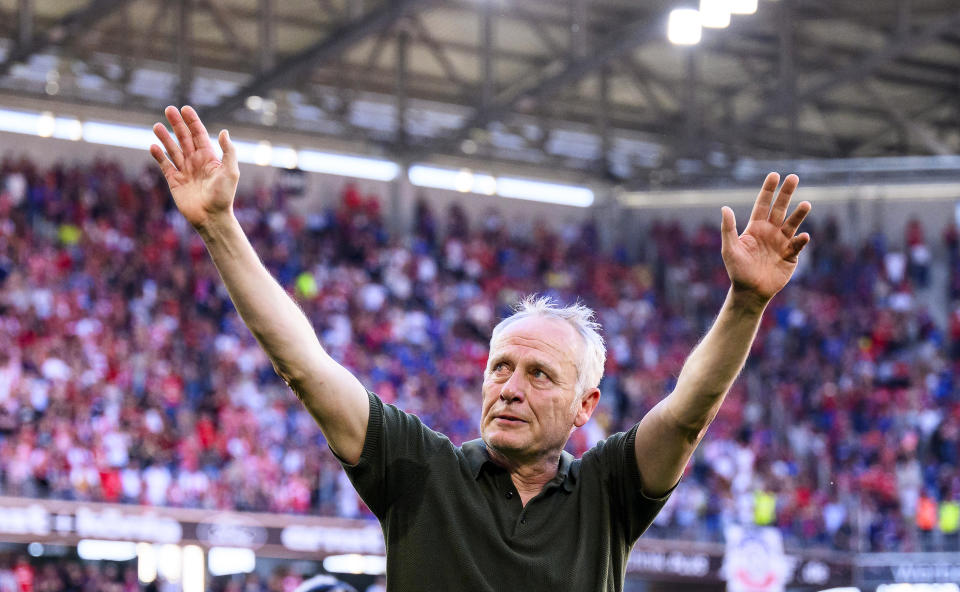 Freiburg's head coach Christian Streich says goodbye to the fans after the German Bundesliga soccer match between SC Freiburg and 1. FC Heidenheim in Freiburg, Germany, Saturday, May 11, 2024. Freiburg drew with Heidenheim 1-1 in Christian Streich’s last home game in charge after more than 12 years as the Freiburg coach. Streich was the Bundesliga’s longest-serving coach but he said in March he would step down at the end of the season. His final game will be at Union Berlin next weekend. (Tom Weller/dpa via AP)