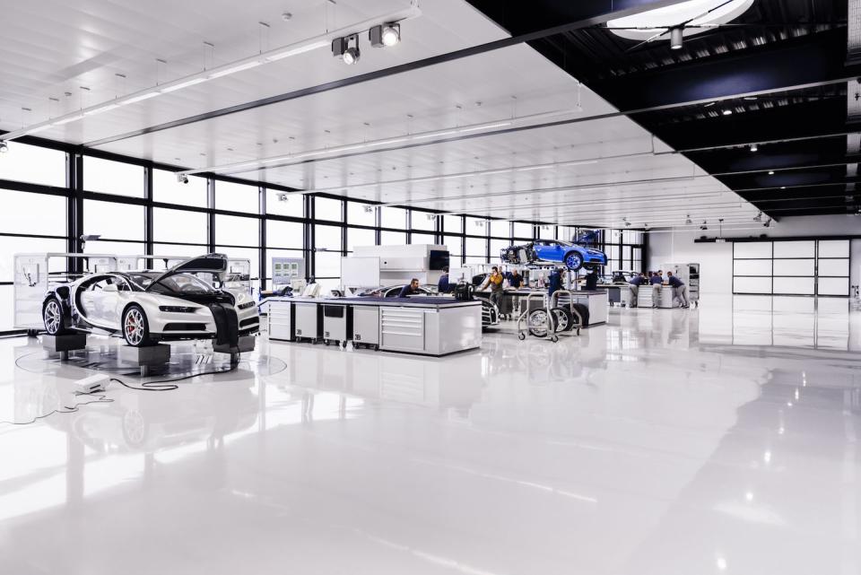 <p>The Bugatti factory in France is more like a workshop than a full-blown manufacturing facility. There are <a rel="nofollow noopener" href="https://www.roadandtrack.com/new-cars/car-technology/g6922/bugatti-chiron-factory-photos-tour/" target="_blank" data-ylk="slk:only 20 people in total;elm:context_link;itc:0;sec:content-canvas" class="link ">only 20 people in total</a> that build the 1500-horsepower <a rel="nofollow noopener" href="https://www.roadandtrack.com/new-cars/first-drives/a33033/bugatti-chiron-first-drive/" target="_blank" data-ylk="slk:Chiron;elm:context_link;itc:0;sec:content-canvas" class="link ">Chiron</a>, each at individual stations within the building - no conveyor belts here. </p>