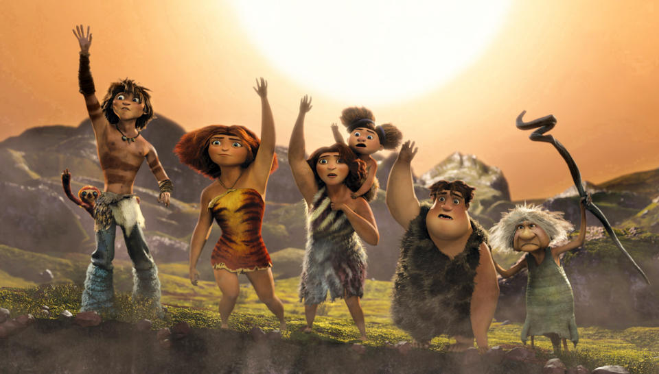 This film publicity image released by DreamWorks Animation shows, from left, Belt the sloth, voiced by Chris Sanders, Guy, voiced by Ryan Reynolds, Eep, voiced by Emma Stone, Ugga, voiced by Catherine Keener, holding Sandy, voiced by Randy Thom, Thunk, voiced by Clark Duke, Gran, voiced by Cloris Leachman, in a scene from "The Croods." (AP Photo/DreamWorks Animation)