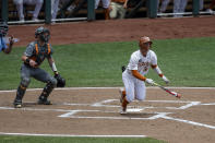 Texas outfielder Eric Kennedy, right, hits a three-run homer in the second inning against Tennessee during a NCAA college baseball game in the College World Series Tuesday, June 22, 2021, at TD Ameritrade Park in Omaha, Neb. (AP Photo/John Peterson)