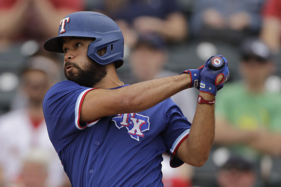 Texas Rangers' Isiah Kiner-Falefa hits an RBI single during the second inning of a spring training baseball game against the Los Angeles Angels Friday, Feb. 28, 2020, in Tempe, Ariz. (AP Photo/Charlie Riedel)