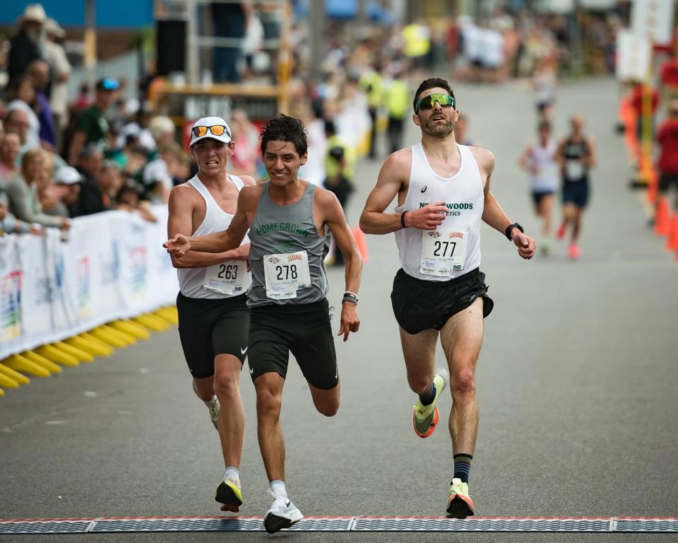 From left: Dillon Vandemortel, Jonathan Zavala and Matthew Zanchi cross the finish line of the Boilermaker 15K Road Race in Utica, NY on Sunday, July 9, 2023.