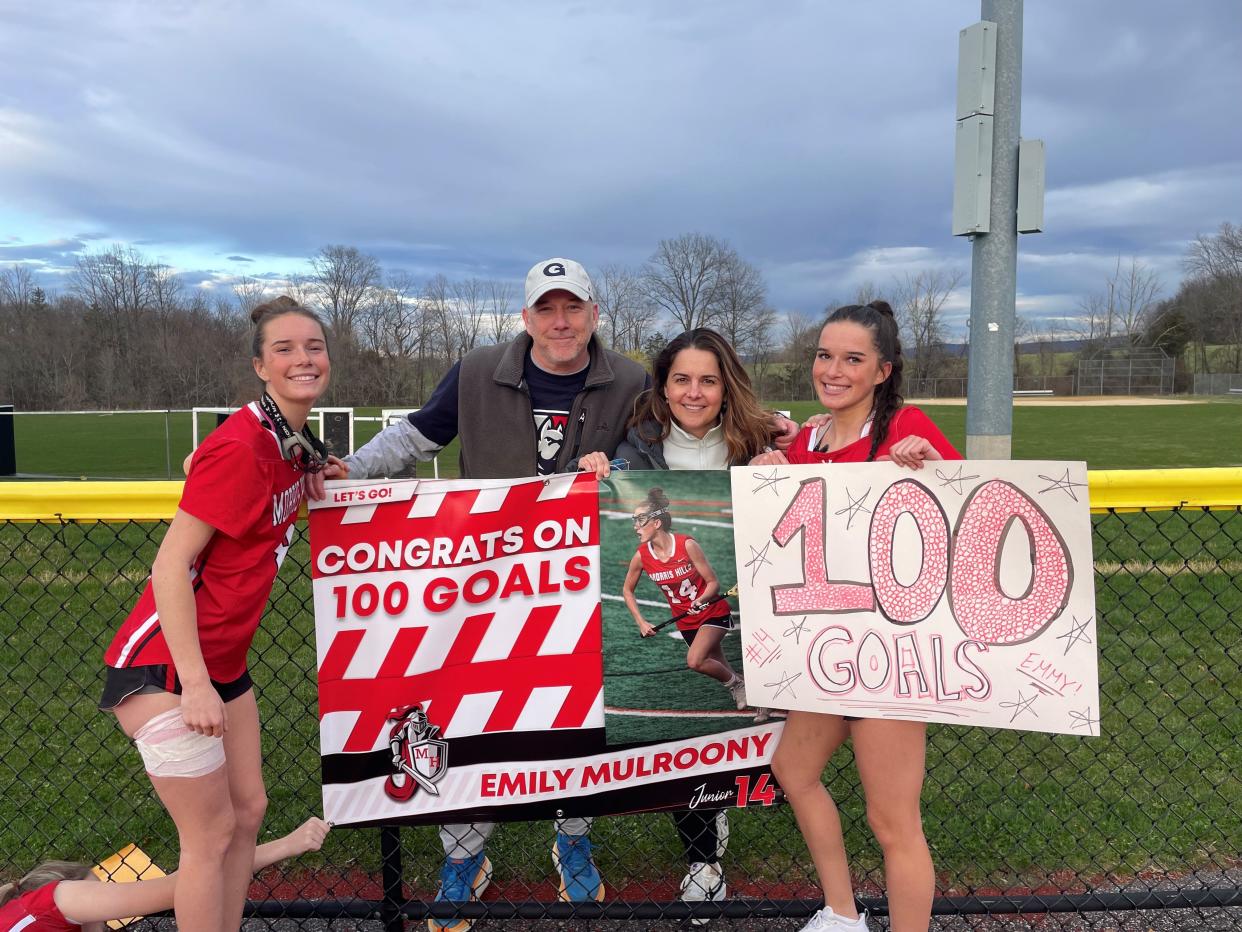 Morris Hills junior Emily Mulroony scored her 100th career goal on April 8, 2024 at Vernon. She celebrates with her older sister, Sydney, and parents Denis and Theresa Mulroony.
