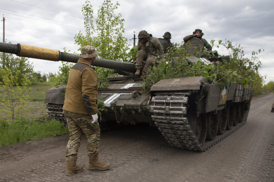 A Ukrainian tank rides on the road near Bakhmut, Donetsk region, Ukraine, Thursday, May 11, 2023. (AP Photo/Boghdan Kutiepov)