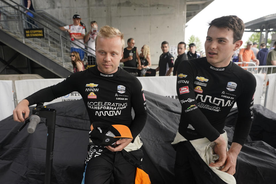 Felix Rosenqvist, left, of Sweden, talks with Pato O'Ward, of Mexico, during qualifications for the Indianapolis 500 auto race at Indianapolis Motor Speedway, Saturday, May 21, 2022, in Indianapolis. (AP Photo/Darron Cummings)