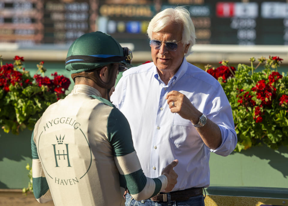 In a photo provided by Benoit Photo, Adare Manor trainer Bob Baffert, right, and jockey Juan Hernandez talk after the horse's victory in the Grade II, $200,000 Santa Maria Stakes horse race Saturday, April 29, 2023,Santa Anita in Arcadia, Calif. (Benoit Photo via AP)