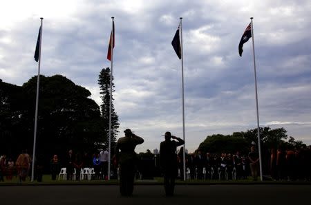 Members of the Australian Defence Forces salute as the Aboriginal and Torres Strait Islander flags are raised along with the New South Wales and Australian national flags during a ceremony at Government House in Sydney, Australia, June 28, 2017. REUTERS/David Gray