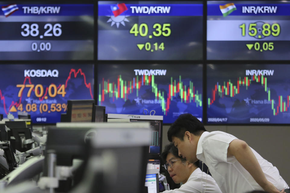 Currency traders watch monitors at the foreign exchange dealing room of the KEB Hana Bank headquarters in Seoul, South Korea, Thursday, July 9, 2020. Asian stock markets followed Wall Street higher on Thursday following gains for major U.S. tech stocks. (AP Photo/Ahn Young-joon)