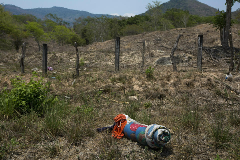 A migrant's bedding lies on the side of the road after after a group of Central American migrants ran away from Mexican immigration agents on the highway through Pijijiapan, Chiapas state, Mexico, Monday, April 22, 2019. Mexican police and immigration agents detained hundreds of migrants Monday in the largest single raid on a migrant caravan since the groups started moving through Mexico last year. (AP Photo/Moises Castillo)