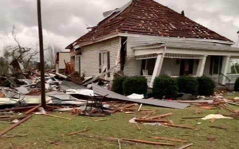 Debris and a damaged house seen following a tornado in Beauregard, Alabama - Credit: Reuters