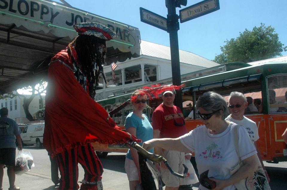 Tourist Janet Sternberg of McMinnville, Tenn., has her picture taken with Captain Booty, retired teacher Bob Kelley, in front of Sloppy Joe’s on Duval Street during her cruise ship stop in Key West.