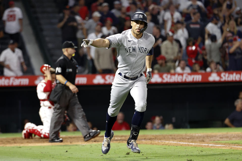 New York Yankees' Giancarlo Stanton celebrates after hitting a two-run home run during the seventh inning of a baseball game against the Los Angeles Angels in Anaheim, Calif., Monday, Aug. 30, 2021. (AP Photo/Ringo H.W. Chiu)