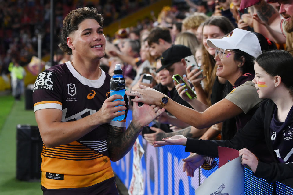 Reece Walsh celebrates with the fans.