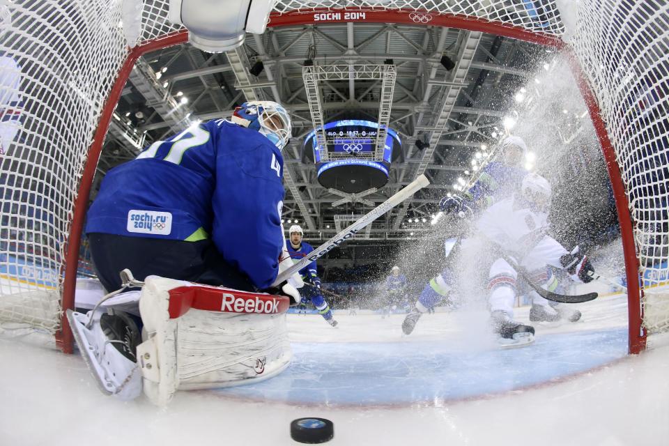 Slovenia goaltender Luka Gracnar looks back at the puck after USA forward Phil Kessel scored period of a men's ice hockey game at the 2014 Winter Olympics, Sunday, Feb. 16, 2014, in Sochi, Russia. (AP Photo/Martin Rose, Getty Images Pool)