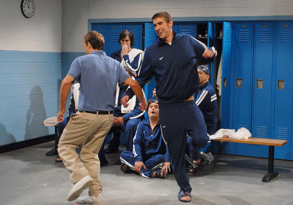 Michael Phelps skipping in a locker room during a sketch