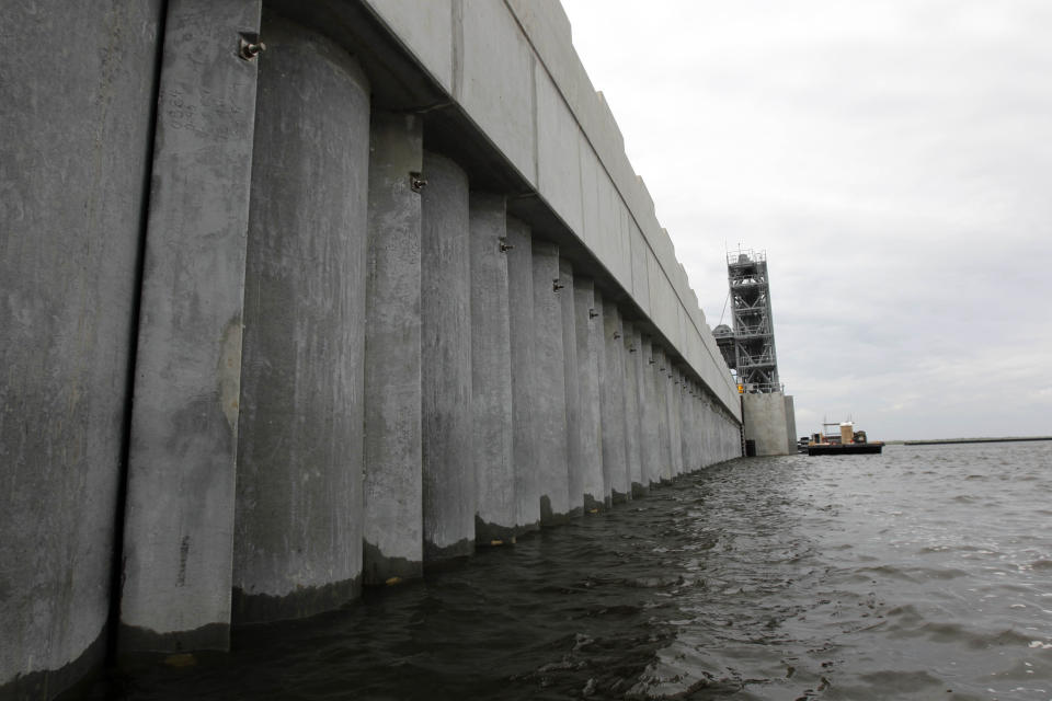 FILE - In this June 22, 2012 file photo, the Inner Harbor Navigation Canal (IHNC) Surge Barrier, constructed after Hurricane Katrina to prevent tidal surges from hurricanes from reaching New Orleans, is seen in St. Bernard Parish, La. New Orleans finds itself in the path of Hurricane Ida 16 years to the day after floodwalls collapsed and levees were overtopped by a storm surge driven by Hurricane Katrina. The federal government spent $14.5 billion on levees, pumps, seawalls, floodgates and drainage that provides enhanced protection from storm surge and flooding in New Orleans and surrounding suburbs south of Lake Pontchartrain. With the exception of three drainage projects, that work is complete (AP Photo/Gerald Herbert, File)