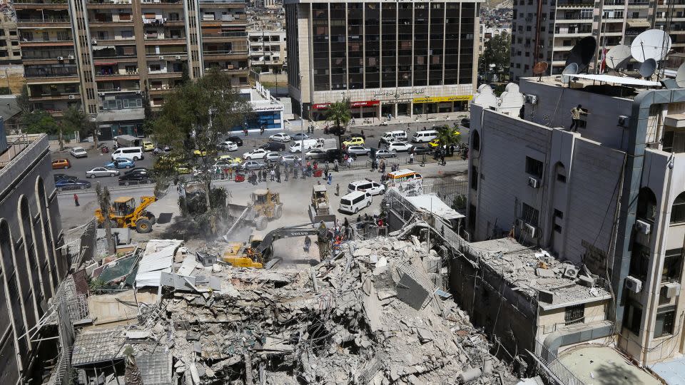 Rescue workers search in the rubble of a building annexed to the Iranian embassy a day after an Israeli air strike in Damascus, Syria, on April 2. - Louai Beshara/AFP/Getty Images