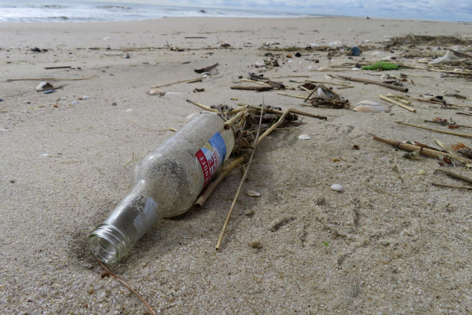 An alcoholic beverage bottle sits on the sand in Brick N.J. on Thursday, April 4, 2024, the day that the Clean Ocean Action Environmental Group released a report showing that volunteers picked up and disposed of 176,206 items of trash along New Jersey's 127-mile coastline last year. (AP Photo/Wayne Parry)