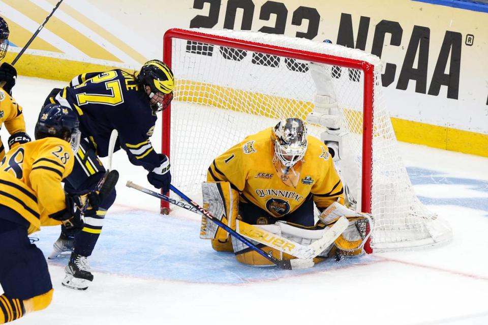 Apr 6, 2023; Tampa, Florida, USA; Quinnipiac goaltender Yaniv Perets (1) saves a shot from Michigan forward Nolan Moyle (27) during the second period in the semifinals of the 2023 Frozen Four college ice hockey tournament at Amalie Arena. Mandatory Credit: Nathan Ray Seebeck-USA TODAY Sports Nathan Ray Seebeck/Nathan Ray Seebeck-USA TODAY Sports