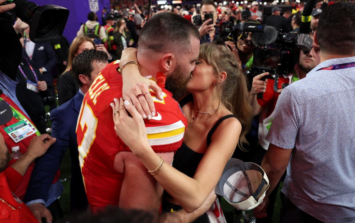 Travis Kelce #87 of the Kansas City Chiefs kisses Taylor Swift after defeating the San Francisco 49ers 2 during Super Bowl