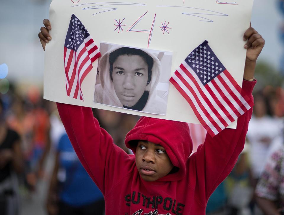 Jaylen Reese, 12, of Atlanta, marches to downtown during a protest of George Zimmerman's not guilty verdict in the 2012 shooting death of teenager Trayvon Martin, Monday, July 15, 2013, in Atlanta.