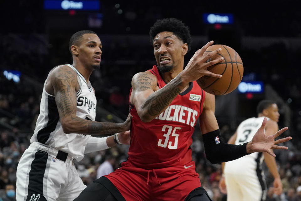 Houston Rockets center Christian Wood (35) drives to the basket against San Antonio Spurs guard Dejounte Murray (5) during the first half of an NBA basketball game, Wednesday, Jan. 12, 2022, in San Antonio. (AP Photo/Eric Gay)