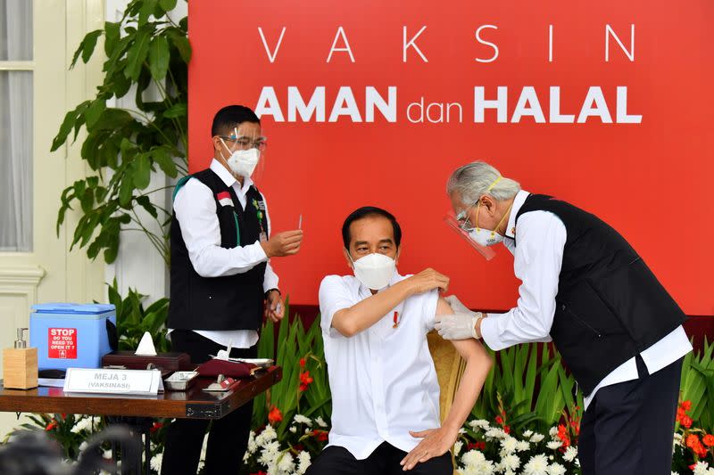 Indonesian President Joko Widodo receives a shot of COVID-19 vaccine at the Merdeka Palace in Jakarta