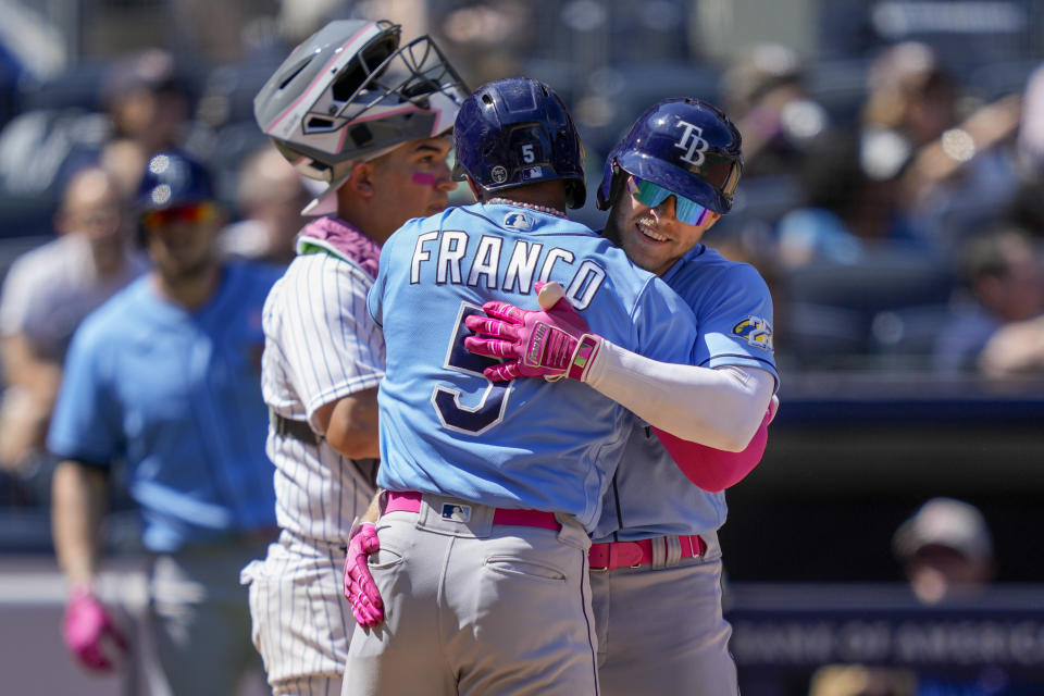 Tampa Bay Rays' Taylor Walls, right, celebrates with Wander Franco (5) after hitting a grand slam off New York Yankees relief pitcher Albert Abreu (84) in the fifth inning of a baseball game, Sunday, May 14, 2023, in New York. (AP Photo/John Minchillo)