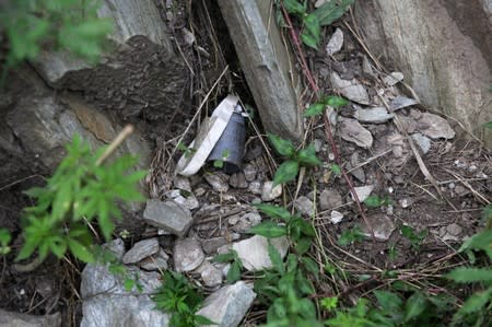 Part of an unexploded cluster bomb is seen near a residential area in village Jabri, in Neelum Valley